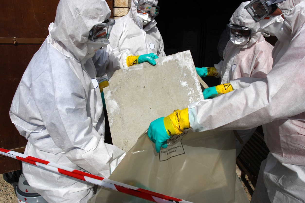 Technician performing professional asbestos abatement